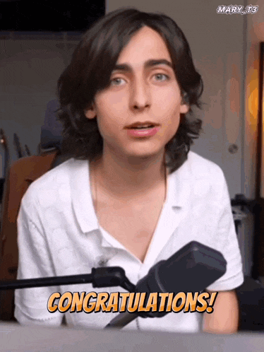 a young man sitting in front of a microphone with the words congratulations on the screen