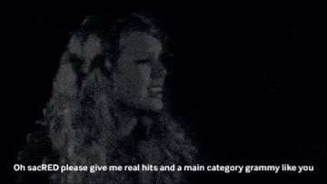 a woman holding a trophy with the words " no hits or main category grammys for you piss now continue crying "