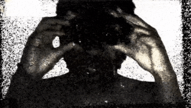 a black and white image of a person taking a selfie