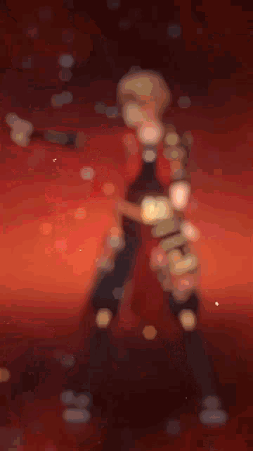 a blurred image of a person standing in front of a sunset