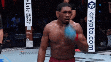 a man in a boxing ring with a banner that says crypto.com on it