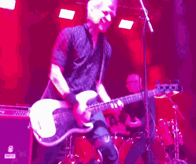 a man playing a bass guitar with a sticker on it that says ' i love you '