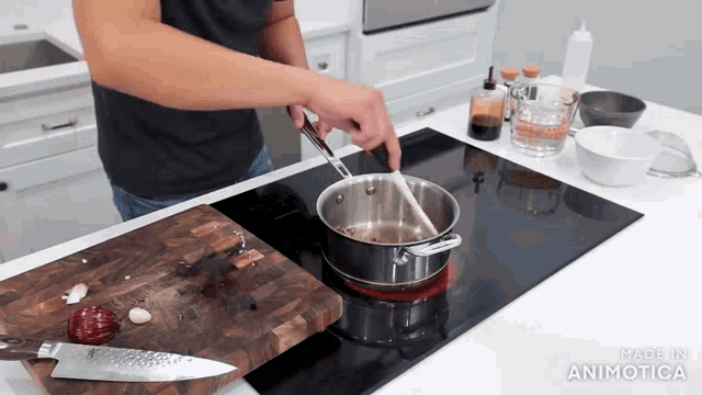 a person is stirring a pot on a stove with the words made in animatica visible