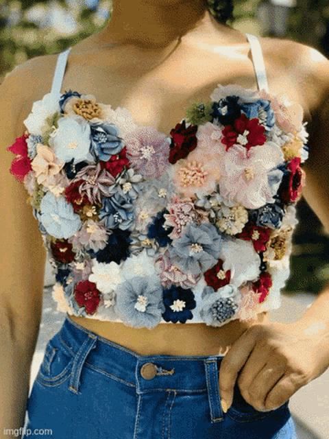 a woman wearing a crop top made of flowers