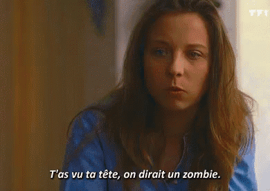 a woman in a red shirt is talking in french
