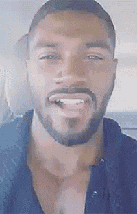 a close up of a man with a beard and mustache smiling in a car .
