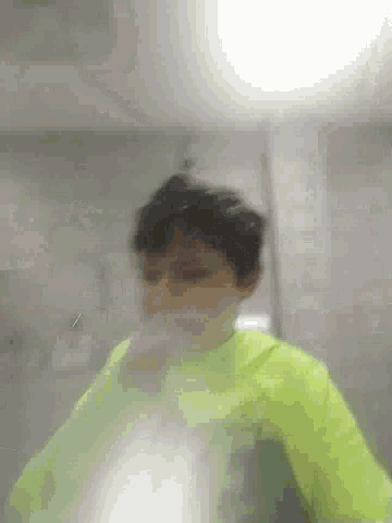 a blurry picture of a person wearing a neon green shirt .