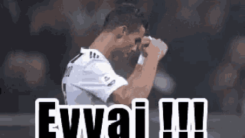 a soccer player wipes his face with a towel and the words ewwai !!! are written below him