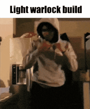 a man in a hoodie is standing in front of a refrigerator with the text light warlock build
