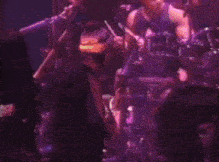 a man singing into a microphone while playing a guitar on a stage
