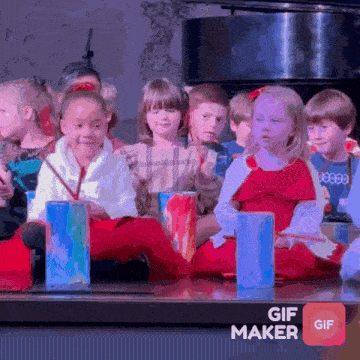 a group of children are sitting on the floor playing drums with a gif maker icon in the corner