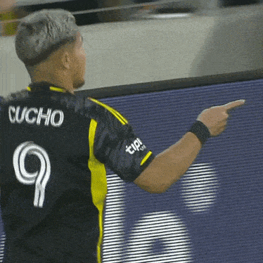 a soccer player with the name cucho on his back