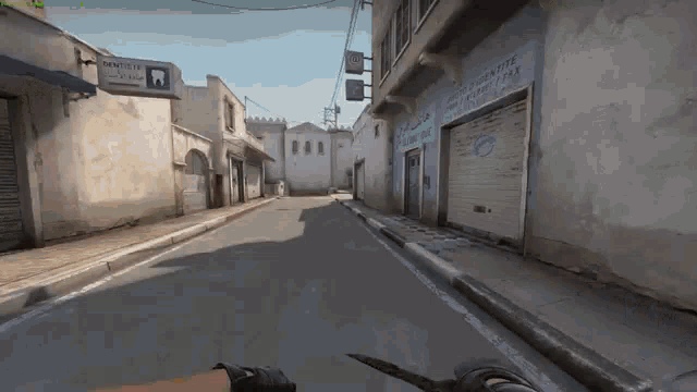 a person is holding a knife in a video game while walking down a narrow street