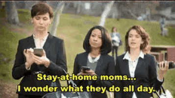 a group of women are standing next to each other and one of them is holding a cell phone