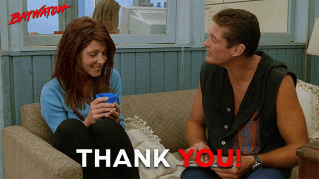 a man and a woman are sitting on a couch with a thank you message behind them