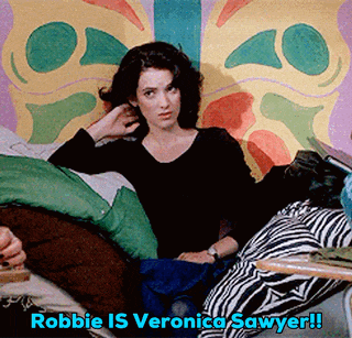 a woman sits on a bed with the words robbie is veronica sawyer