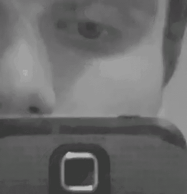 a black and white photo of a cell phone with a square button on it