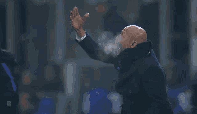a man with smoke coming out of his mouth is wearing a black coat
