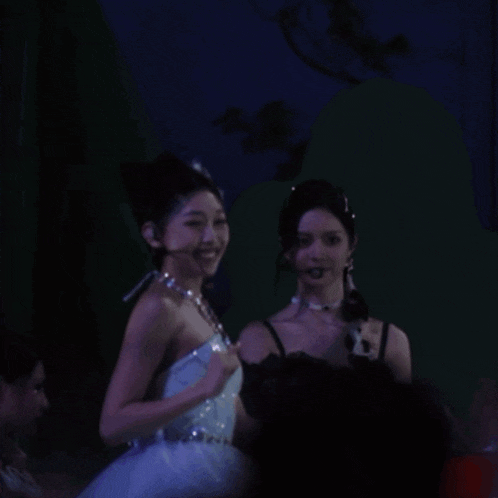 a woman in a white dress is dancing in the dark