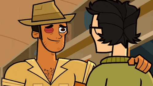 a man in a cowboy hat talks to a man in a green sweater