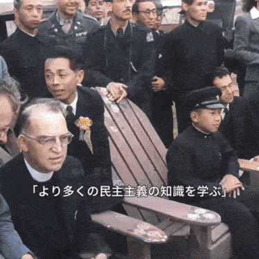 a group of men are sitting in a wooden chair with chinese writing on the bottom right