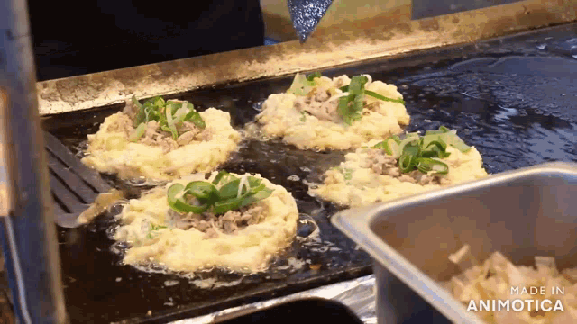 food being cooked on a grill with the words made in animotica visible