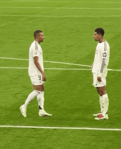 two soccer players one of whom has the number 9 on his shirt