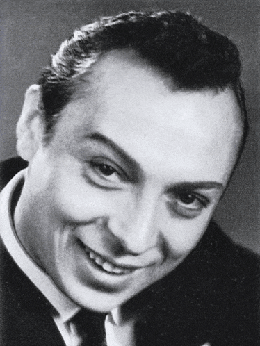 a black and white photo of a man smiling