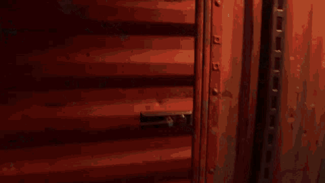 a close up of a red door with a handle on it .