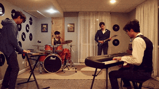 a man playing a keyboard in front of a drum set that says pearl