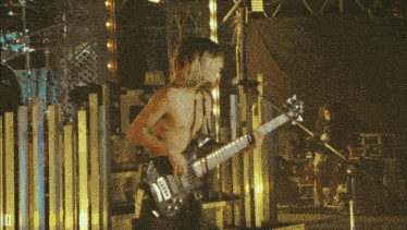 a man playing a guitar with the number 18 on the back