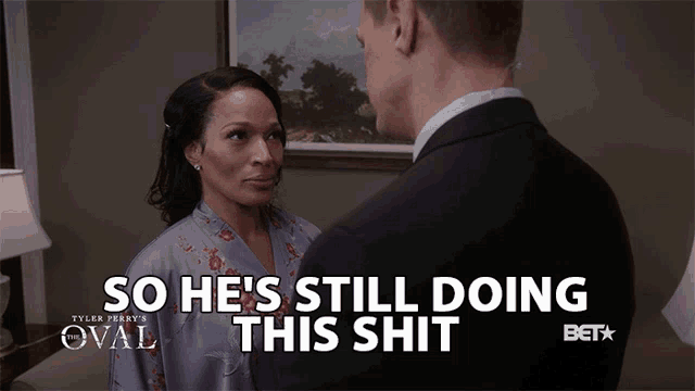a man and a woman are looking at each other and the man is saying so he 's still doing this shit
