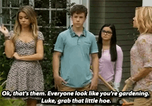 a group of people are standing in front of a house and one of them says ok that 's them .