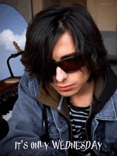 a man wearing sunglasses and a denim jacket says it 's only wednesday .