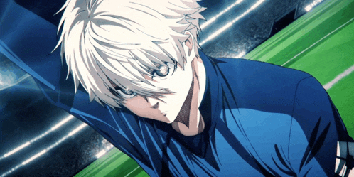 a man with white hair and a blue shirt stands on a field