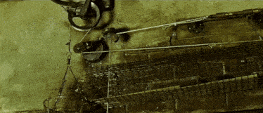 a close up of a machine with wheels and a rope hanging from it