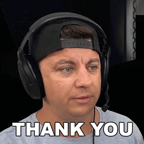 a man wearing headphones and a hat says " thank you "