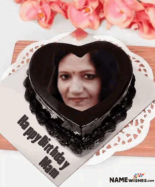 a heart shaped chocolate cake with a picture of a woman on it