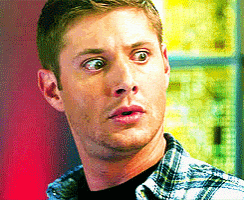 a man in a plaid shirt has a surprised look on his face