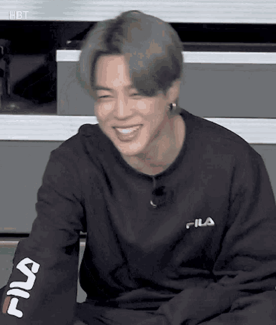 a close up of a person wearing a black sweatshirt and smiling .