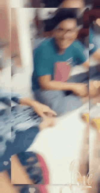 a blurry picture of a person sitting on a bed
