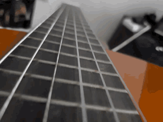 a close up of a guitar 's neck shows the frets and strings