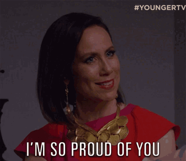 a woman says i 'm so proud of you while wearing a gold necklace
