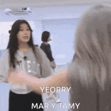 two girls are hugging each other with the words yeorry mary tamy in the corner