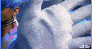 a person with blue hair is looking at a statue of a skeleton