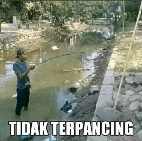 a man is fishing in a river with a caption that says tidak terpancing
