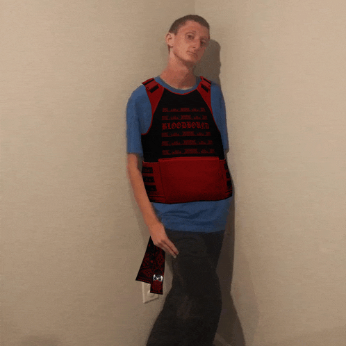 a man wearing a red vest that says bloodbathed