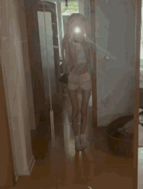 a woman taking a selfie in front of a mirror