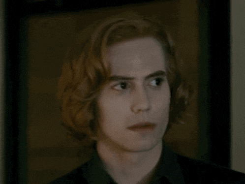 a close up of a man with long red hair