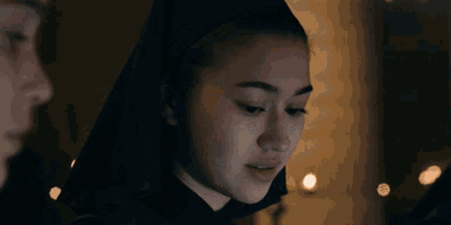 a woman in a dark room with the words " not everything " below her